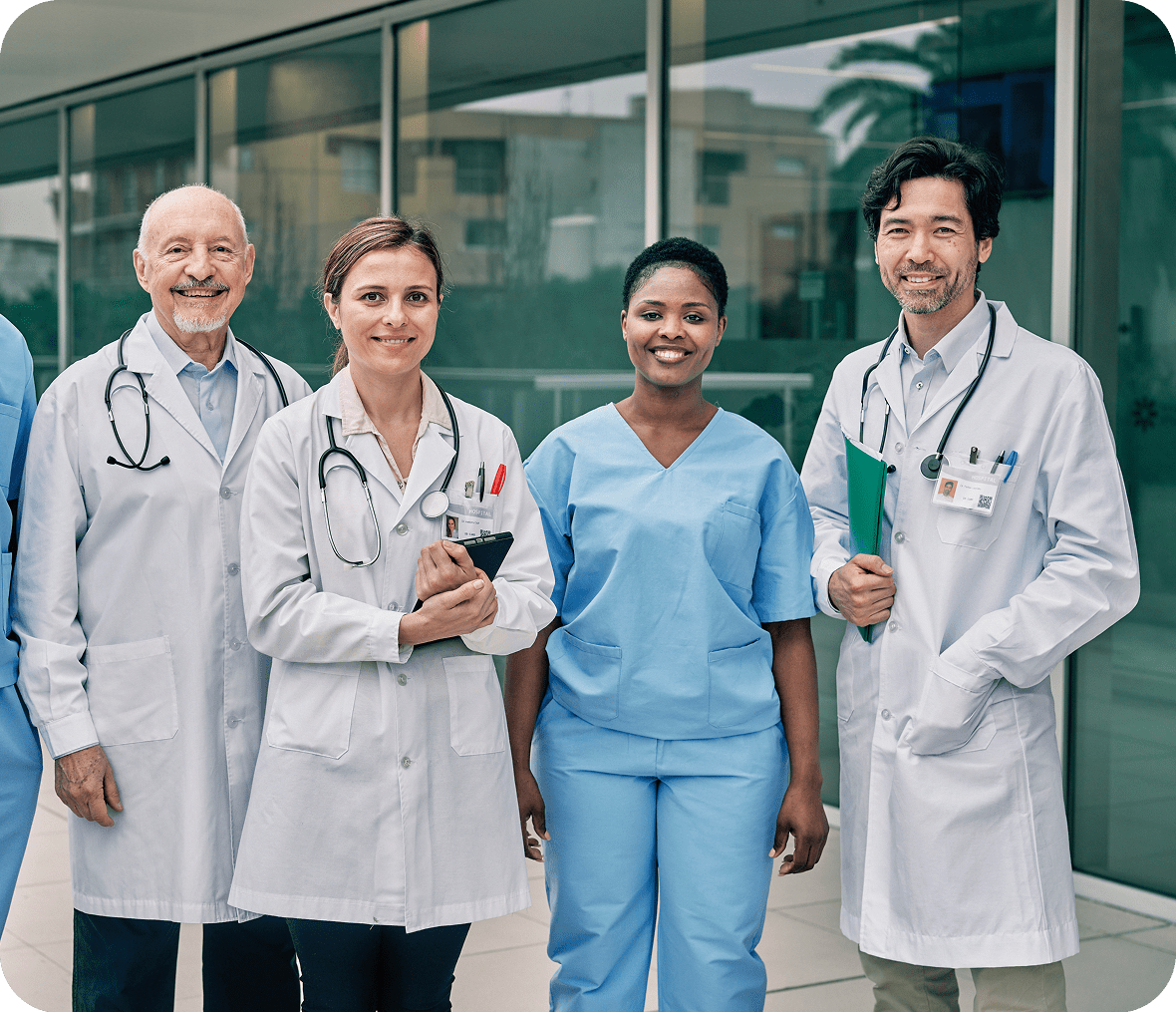 Medical team standing together, smiling confidently.
