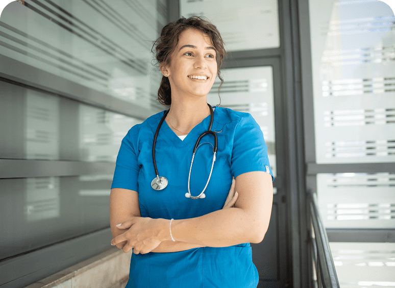 Smiling nurse in blue scrubs and stethoscope.