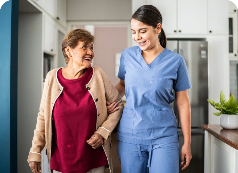 Caregiver assisting elderly woman at home.