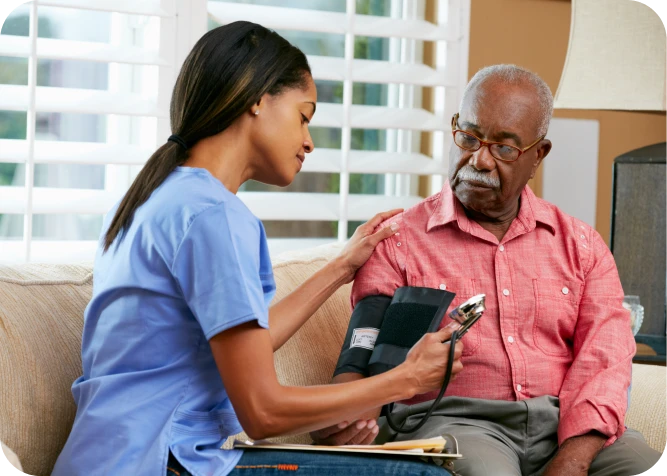 Nurse interacting with elderly women in wheelchairs.